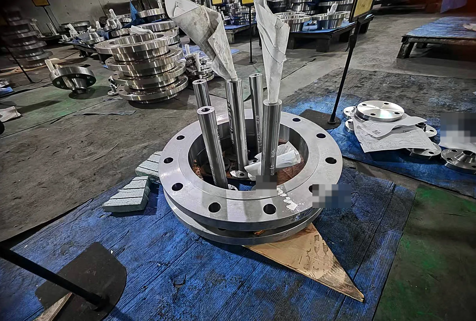Carbon steel flange blanks stacked in fabrication shop