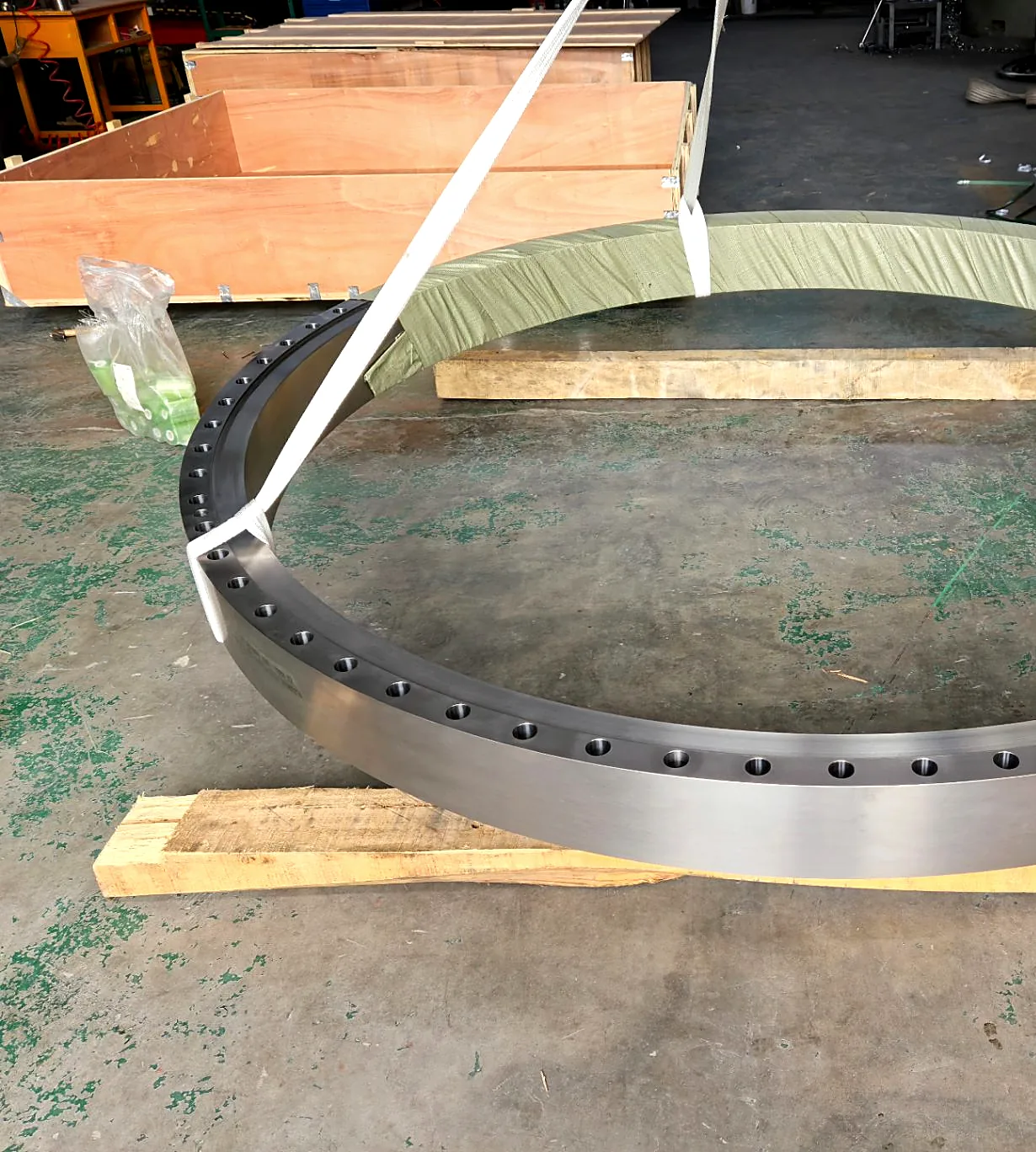 Large titanium flange rigged with lifting slings, crated for sea freight